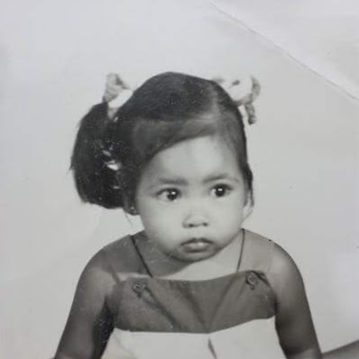 Old black and white passport photo of a small filipino child