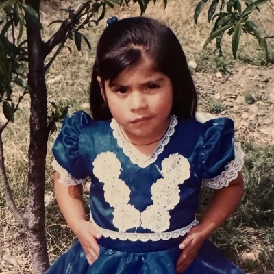 Latina little girl outside looking at the camera